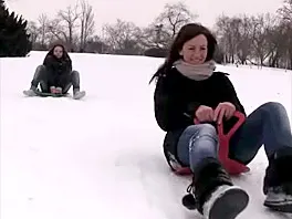 Two cute girls on a sled